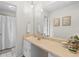 Well-lit bathroom featuring a spacious vanity, decorative mirror, and neutral decor at 1068 Gwens Sw Trl, Lilburn, GA 30047