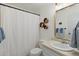 Well-lit bathroom featuring a white shower curtain and sleek vanity mirror at 1068 Gwens Sw Trl, Lilburn, GA 30047