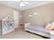 A bright bedroom features a bed, bookshelf and a window with natural light at 1068 Gwens Sw Trl, Lilburn, GA 30047