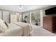 Bright bedroom with balcony access, plush carpet, large windows, and light-blocking curtains at 1068 Gwens Sw Trl, Lilburn, GA 30047