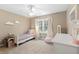 Cozy bedroom featuring bright window, plush carpet, and unique decorative accents at 1068 Gwens Sw Trl, Lilburn, GA 30047