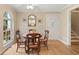 Cozy dining area featuring hardwood floors, an arched window, and seating for four at 1068 Gwens Sw Trl, Lilburn, GA 30047