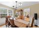 Bright dining area featuring hardwood floors and a large window for natural light at 1068 Gwens Sw Trl, Lilburn, GA 30047