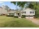 Charming two-story home with a well-manicured lawn, two car garage, and a welcoming front porch at 1068 Gwens Sw Trl, Lilburn, GA 30047