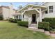 Inviting front porch with a covered entryway, complemented by trimmed hedges at 1068 Gwens Sw Trl, Lilburn, GA 30047