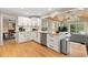 Open kitchen with granite countertops, stainless appliances, and seamlessly connected to the living area at 1068 Gwens Sw Trl, Lilburn, GA 30047