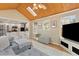 Comfortable living room area with hardwood floors, wood ceiling and natural light from the skylight at 1068 Gwens Sw Trl, Lilburn, GA 30047