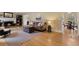 Spacious living room with a decorative fireplace, hardwood floors, and neutral decor at 1068 Gwens Sw Trl, Lilburn, GA 30047