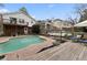 Backyard with a kidney-shaped pool, patio seating, and lush greenery, perfect for outdoor entertaining at 1068 Gwens Sw Trl, Lilburn, GA 30047