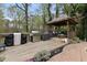 Poolside kitchen featuring a stainless steel grill and a charming gazebo with seating and outdoor decor at 1068 Gwens Sw Trl, Lilburn, GA 30047