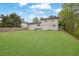 View of the backyard featuring a large lawn and the back of the house at 1449 Hoy Taylor Dr, Norcross, GA 30093