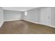 Basement area featuring a utility door, large window, and light-colored wood flooring at 1449 Hoy Taylor Dr, Norcross, GA 30093