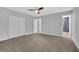 Bedroom featuring neutral paint, a ceiling fan, and a doorway leading to the bathroom at 1449 Hoy Taylor Dr, Norcross, GA 30093