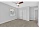 This bedroom features a ceiling fan, a window for natural light, and a double door closet at 1449 Hoy Taylor Dr, Norcross, GA 30093