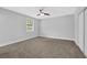 Large bedroom featuring neutral paint, a ceiling fan, closet doors, and a window at 1449 Hoy Taylor Dr, Norcross, GA 30093