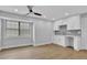 Open concept kitchen with white cabinetry, hardwood floors, and a large window at 1449 Hoy Taylor Dr, Norcross, GA 30093
