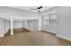 Spacious living room offering ample natural light, a ceiling fan, and light-colored wood flooring at 1449 Hoy Taylor Dr, Norcross, GA 30093