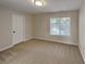 Inviting bedroom with fresh paint, neutral carpeting, and a window providing lots of natural light at 4480 Maple Valley Dr, Cumming, GA 30040