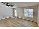 Bright living area with fresh paint, wood-look flooring, a glass patio door and a window providing lots of natural light at 4480 Maple Valley Dr, Cumming, GA 30040