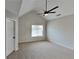 Light-filled main bedroom with vaulted ceiling, modern ceiling fan, neutral carpet and a window with backyard views at 4480 Maple Valley Dr, Cumming, GA 30040