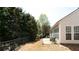 A backyard patio with comfortable seating overlooks green grass at 4520 Vanadium Bnd, Cumming, GA 30040