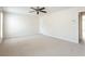 Spacious bedroom features a ceiling fan and neutral carpet flooring creating a serene atmosphere at 4520 Vanadium Bnd, Cumming, GA 30040