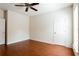 Bright bedroom with hardwood floors, ceiling fan, and ample closet space at 4520 Vanadium Bnd, Cumming, GA 30040