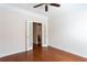 Bedroom with hardwood floors and french door access to bathroom at 4520 Vanadium Bnd, Cumming, GA 30040