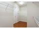Spacious walk-in closet with custom shelves and racks for optimal storage at 4520 Vanadium Bnd, Cumming, GA 30040