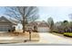 A charming house with a two-car garage is complimented by a green lawn at 4520 Vanadium Bnd, Cumming, GA 30040