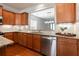 Kitchen with stainless steel appliances and granite counters, showcasing open layout to adjacent dining area at 4520 Vanadium Bnd, Cumming, GA 30040
