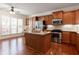 Well-equipped kitchen with a center island, stainless steel appliances, and wood cabinetry at 4520 Vanadium Bnd, Cumming, GA 30040