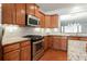 Kitchen with granite countertops, stainless steel appliances, and wood cabinets with under cabinet lighting at 4520 Vanadium Bnd, Cumming, GA 30040