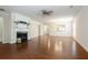 Living room featuring hardwood floors, a fireplace, and ample space at 4520 Vanadium Bnd, Cumming, GA 30040