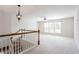 Bright loft featuring a decorative chandelier, ceiling fan, natural light, and staircase at 4520 Vanadium Bnd, Cumming, GA 30040