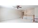 Spacious loft area with ceiling fan, neutral walls, and carpet flooring perfect for versatile use at 4520 Vanadium Bnd, Cumming, GA 30040