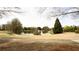 Scenic pond with a fountain, surrounded by green spaces, trees, and a walking path at 4520 Vanadium Bnd, Cumming, GA 30040