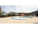 A community pool with beach access, splash features, water slide, and lots of seating available for residents and guests at 4520 Vanadium Bnd, Cumming, GA 30040