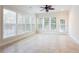 Bright sunroom featuring tile floors, a ceiling fan, and lots of natural light from large windows at 4520 Vanadium Bnd, Cumming, GA 30040