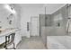 Well-lit bathroom features a soaking tub, glass enclosed shower, and modern vanity at 5085 Mundy Dr, Cumming, GA 30028