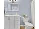 Updated bathroom featuring a white vanity with drawers, a modern mirror and tiled floors at 5085 Mundy Dr, Cumming, GA 30028