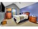 Inviting bedroom with vaulted ceiling, dark blue accent walls, a TV, and cozy furnishings at 5085 Mundy Dr, Cumming, GA 30028