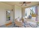 Cozy covered patio with wicker furniture, ceiling fan, and easy access to the backyard at 5085 Mundy Dr, Cumming, GA 30028