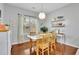 Bright breakfast area featuring hardwood floors, a modern light fixture, and a sunny window view at 5085 Mundy Dr, Cumming, GA 30028
