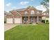 Charming brick home with a welcoming front porch, manicured lawn, and attached two-car garage at 5085 Mundy Dr, Cumming, GA 30028