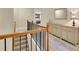 Hallway featuring wood handrail, neutral paint and adjacent cabinet at 5085 Mundy Dr, Cumming, GA 30028