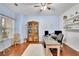 Bright home office featuring a large desk, hardwood floors, and a cozy, functional workspace at 5085 Mundy Dr, Cumming, GA 30028
