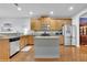 Well-equipped kitchen with wood cabinets, granite countertops, stainless steel appliances, and a center island at 5085 Mundy Dr, Cumming, GA 30028