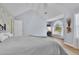 Comfortable main bedroom featuring a vaulted ceiling, wood floors, and a large window with natural light at 5085 Mundy Dr, Cumming, GA 30028