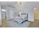 Comfortable main bedroom featuring a vaulted ceiling, decorative wallpaper and wood floors at 5085 Mundy Dr, Cumming, GA 30028